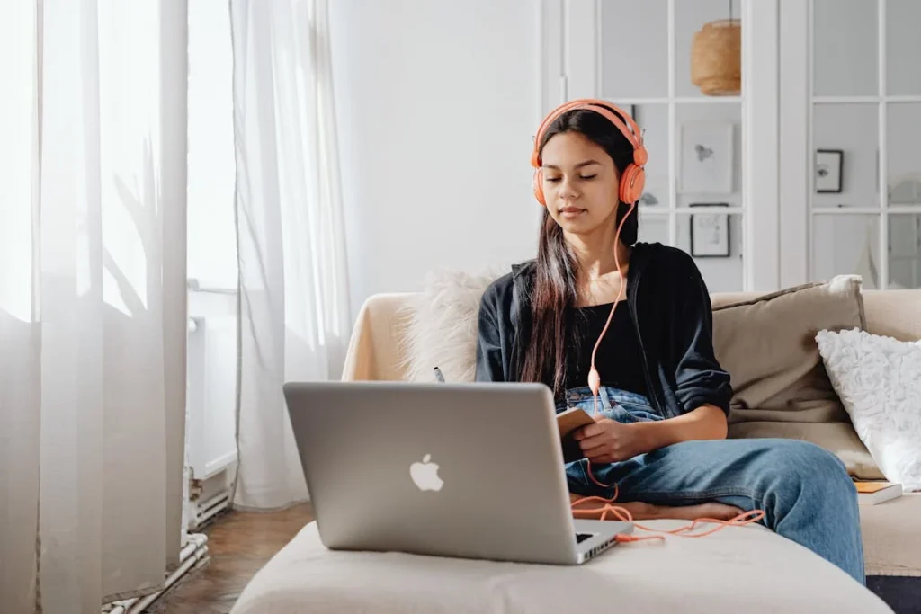 A student focusing on her laptop screen during an online neurodivergent learning support session